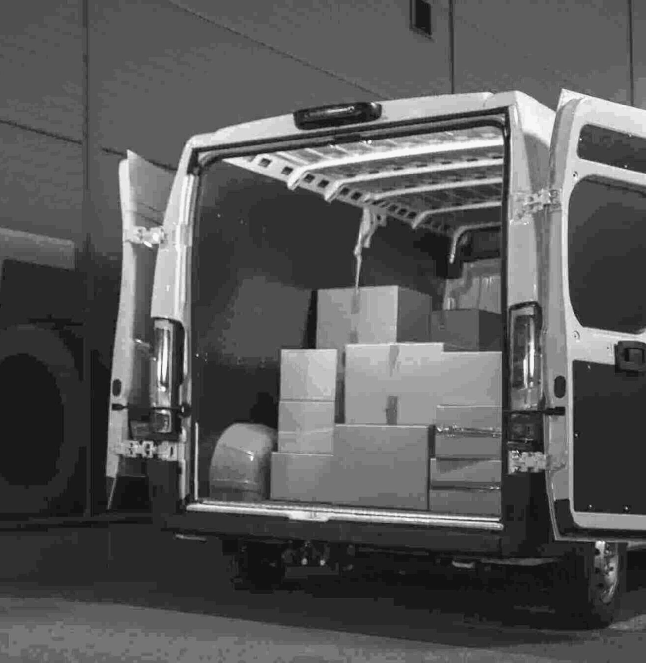 Cartons loaded into a van at the dock door